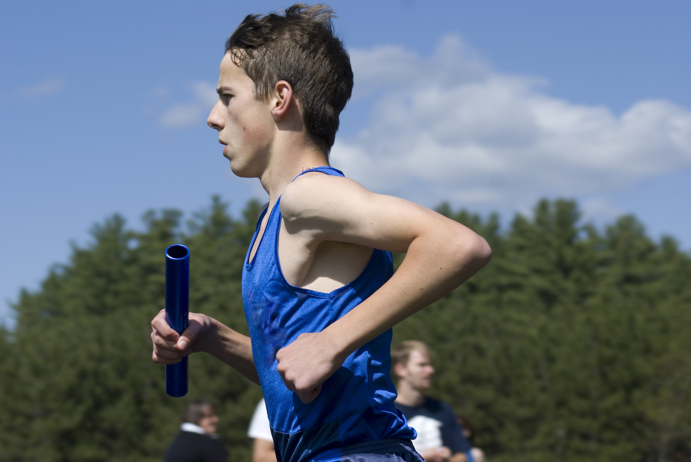 boy running with a baton